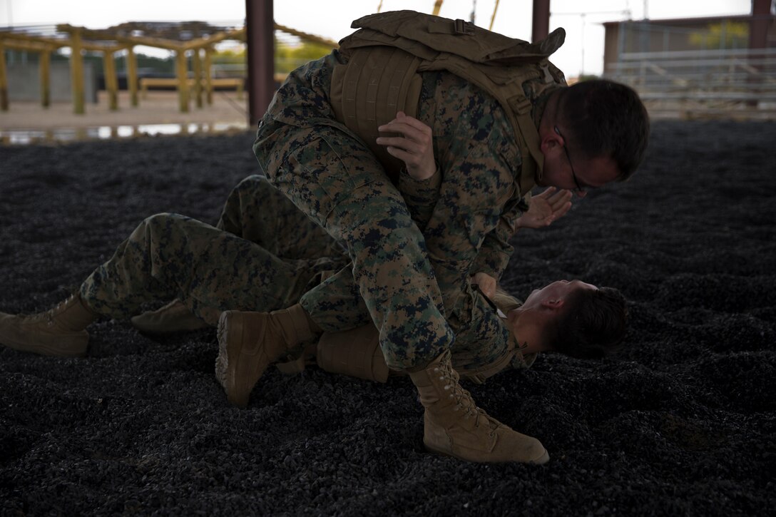 U.S. Marines with Headquarters and Headquarters Squadron practice Marine Corps Martial Arts Program techniques at Marine Corps Air Station Yuma Ariz., April 16, 2019. MCMAP is a combat system developed by the United States Marine Corps to combine techniques with morale and team-building functions and instruction in the warrior ethos. (U.S. Marine Corps photo by Lance Cpl. Joel Soriano)