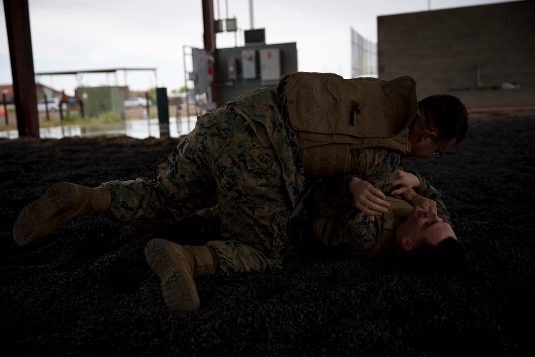 U.S. Marines with Headquarters and Headquarters Squadron practice Marine Corps Martial Arts Program techniques at Marine Corps Air Station Yuma Ariz., April 16, 2019. MCMAP is a combat system developed by the United States Marine Corps to combine techniques with morale and team-building functions and instruction in the warrior ethos. (U.S. Marine Corps photo by Lance Cpl. Joel Soriano)