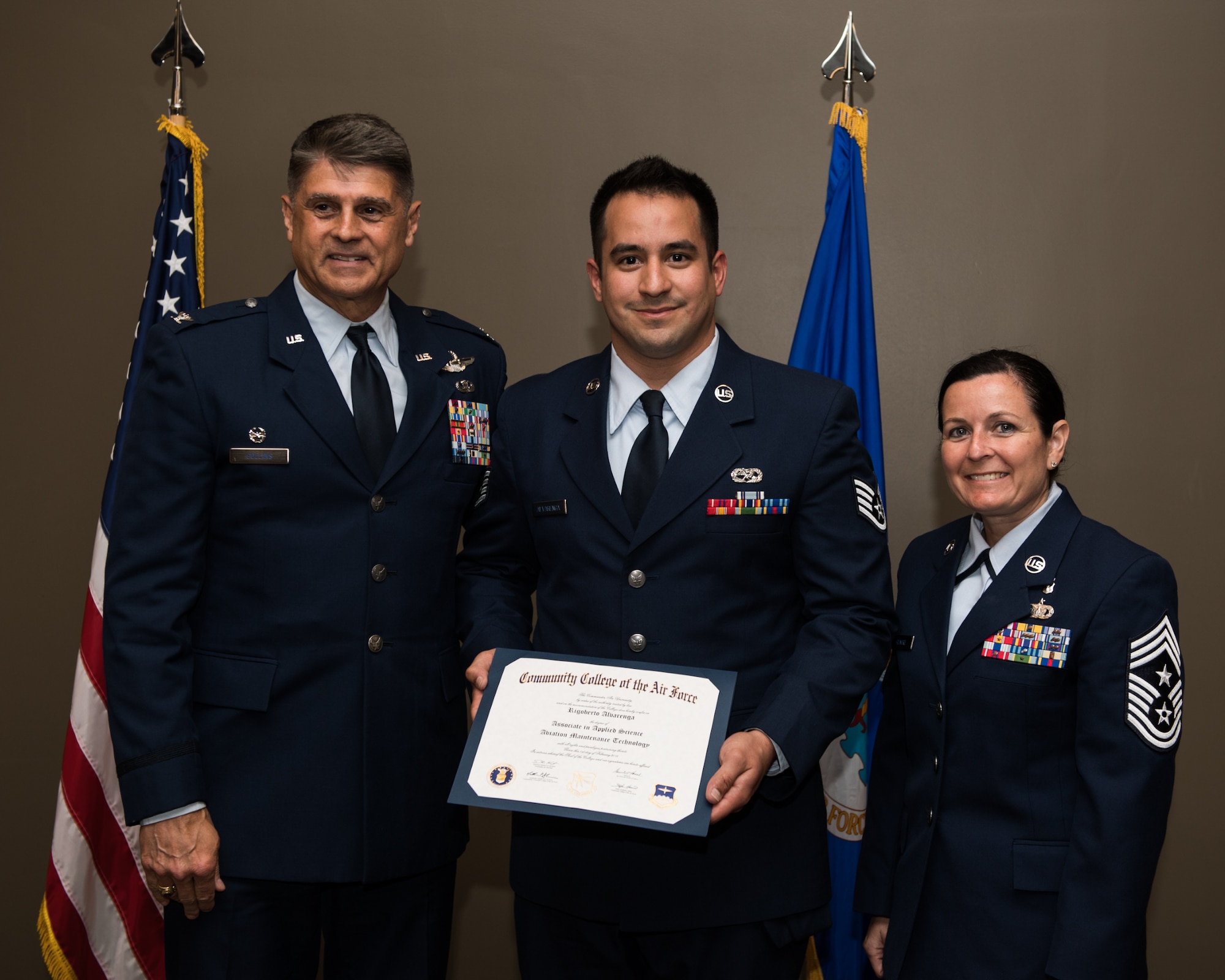 Staff Sgt. Rigoberto Alvarenga, with the 932nd Airlift Wing, receives his Community College of the Air Force associate degree in applied science certificate from 932nd AW commander, Col. Glenn Collins during a CCAF graduation ceremony, June 2, 2019, Scott Air Force Base, Illinois. Wing leadership and fellow Airmen joined the graduates to celebrate their higher education accomplishment. (U.S. Air Force photo by Master Sgt. Christopher Parr)