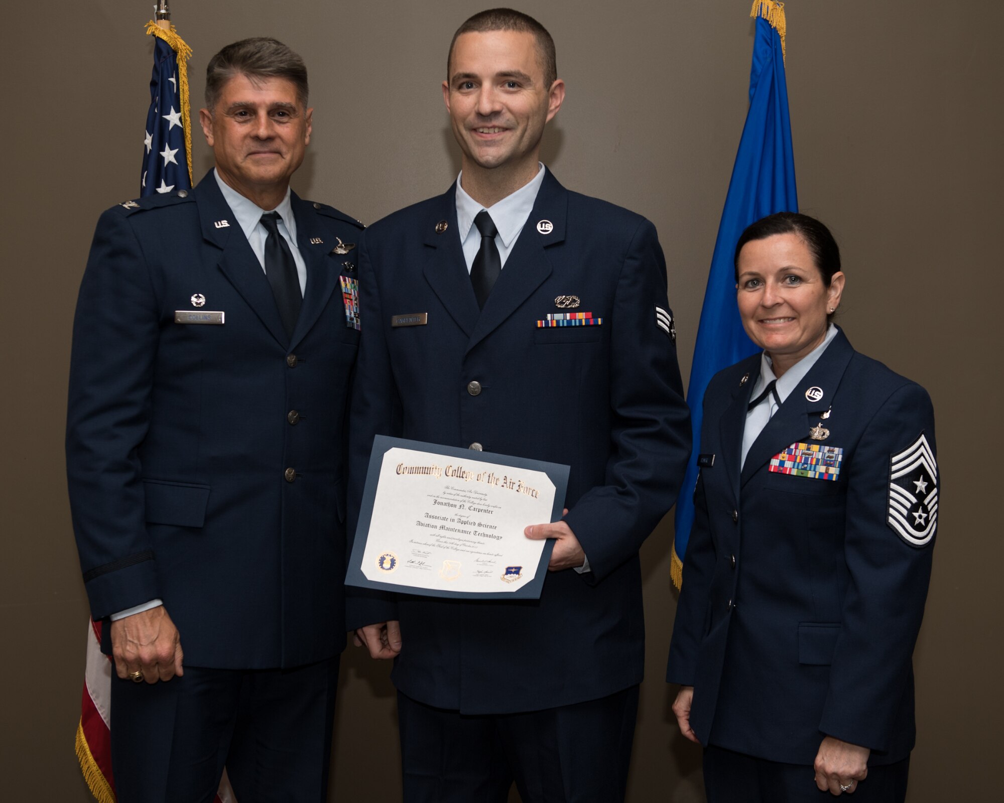 Senior Airmen Jonathon Carpenter, with the 932nd Airlift Wing, receives his Community College of the Air Force associate degree in applied science certificate from 932nd AW commander, Col. Glenn Collins during a CCAF graduation ceremony, June 2, 2019, Scott Air Force Base, Illinois. Wing leadership and fellow Airmen joined the graduates to celebrate their higher education accomplishment. (U.S. Air Force photo by Master Sgt. Christopher Parr)