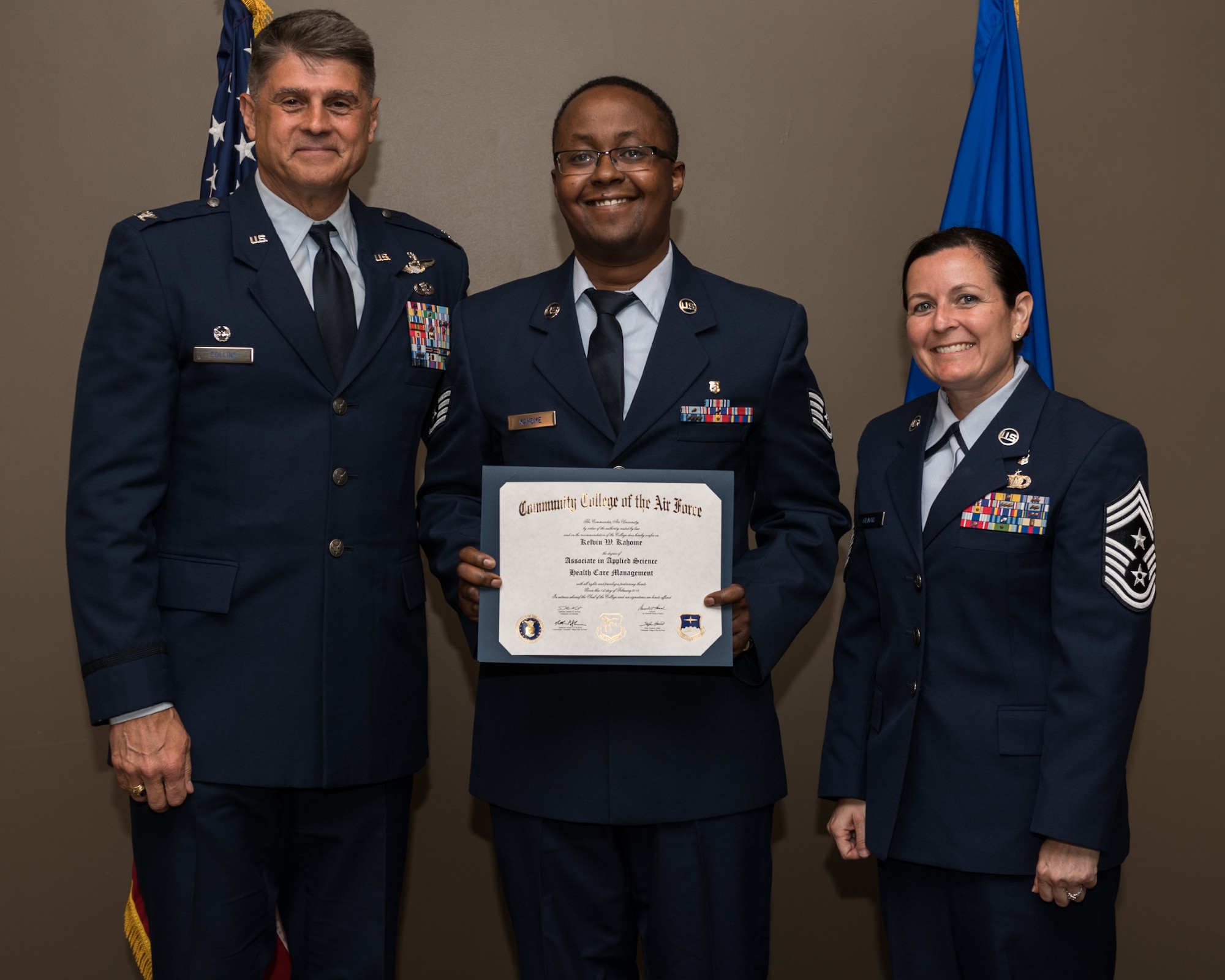 Staff Sgt. Kelvin Kahome, with the 932nd Airlift Wing, receives his Community College of the Air Force associate degree in applied science certificate from 932nd AW commander, Col. Glenn Collins during a CCAF graduation ceremony, June 2, 2019, Scott Air Force Base, Illinois. Wing leadership and fellow Airmen joined the graduates to celebrate their higher education accomplishment. (U.S. Air Force photo by Master Sgt. Christopher Parr)