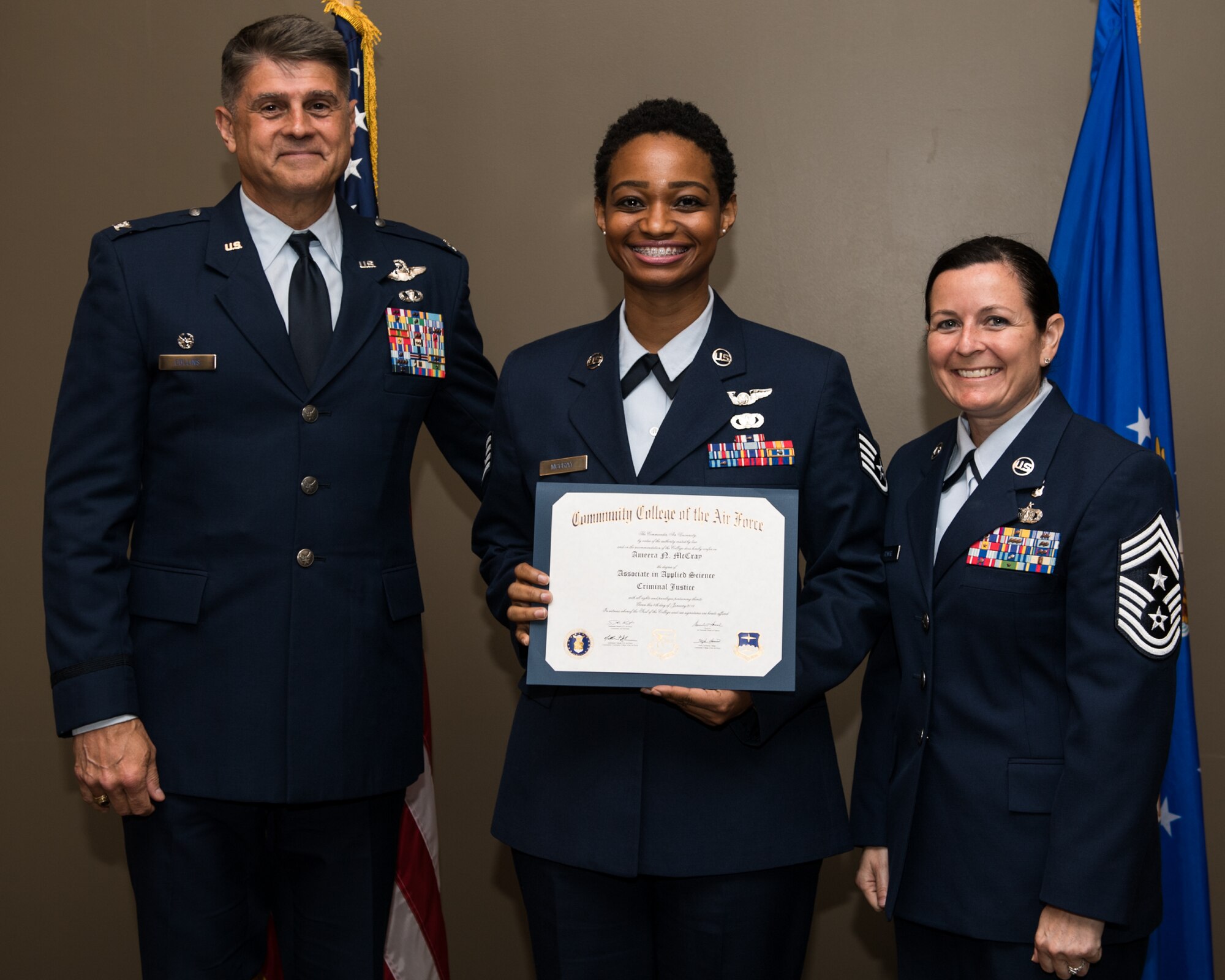 Staff Sgt. Amber McCray, with the 932nd Airlift Wing, receives her Community College of the Air Force associate degree in applied science certificate from 932nd AW commander, Col. Glenn Collins during a CCAF graduation ceremony, June 2, 2019, Scott Air Force Base, Illinois. Wing leadership and fellow Airmen joined the graduates to celebrate their higher education accomplishment. (U.S. Air Force photo by Master Sgt. Christopher Parr)