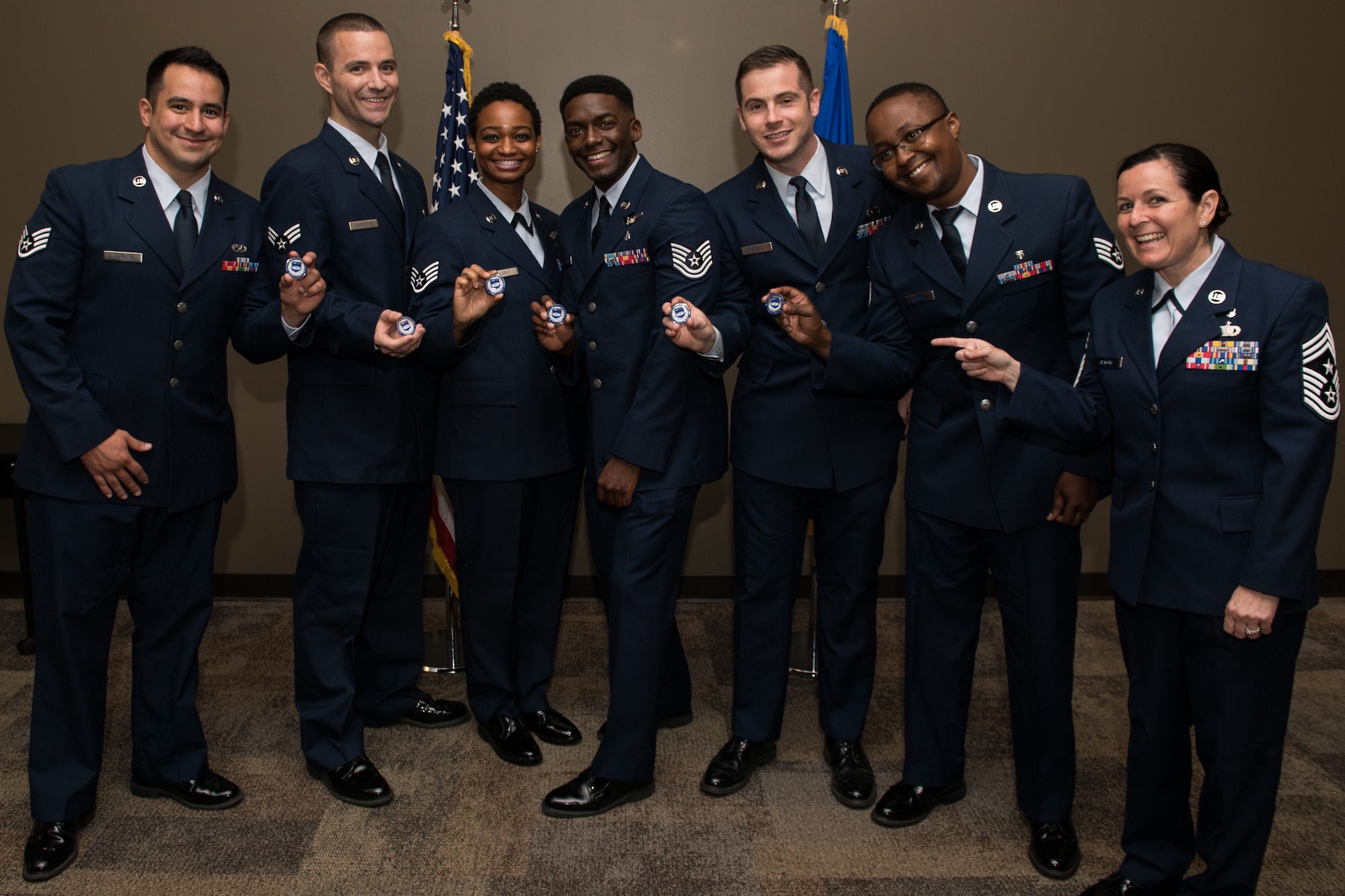 Attending graduates pose with Command Chief Master Sgt. Barbara Gilmore, 932nd Airlift Wing, after receiving their CCAF diplomas and a Wing coin, June 2, 2019, Scott Air Force Base, Illinois. (U.S. Air Force photo by Master Sgt. Christopher Parr)