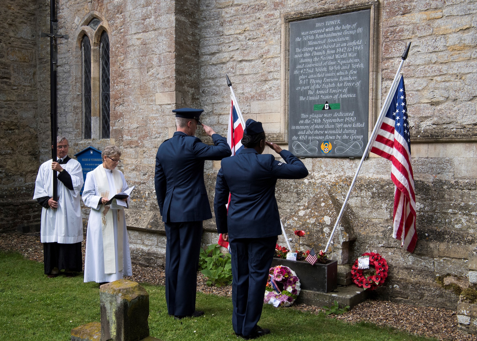 A reverend with the St. John the Baptist Chelveston Church in Chelveston, England, provides a religious service to include Airmen from the 305th Air Mobility Wing, Joint Base McGuire-Dix-Lakehurst, New Jersey, May 26, 2019. The service, which payed respects to the 305th Bomb Group which has evolved into the 305th AMW, was a group of over 4,000 military members that fought in World War II to defend and attack against axis powers. (U.S. Air Force photo by Senior Airman Jake Carter)