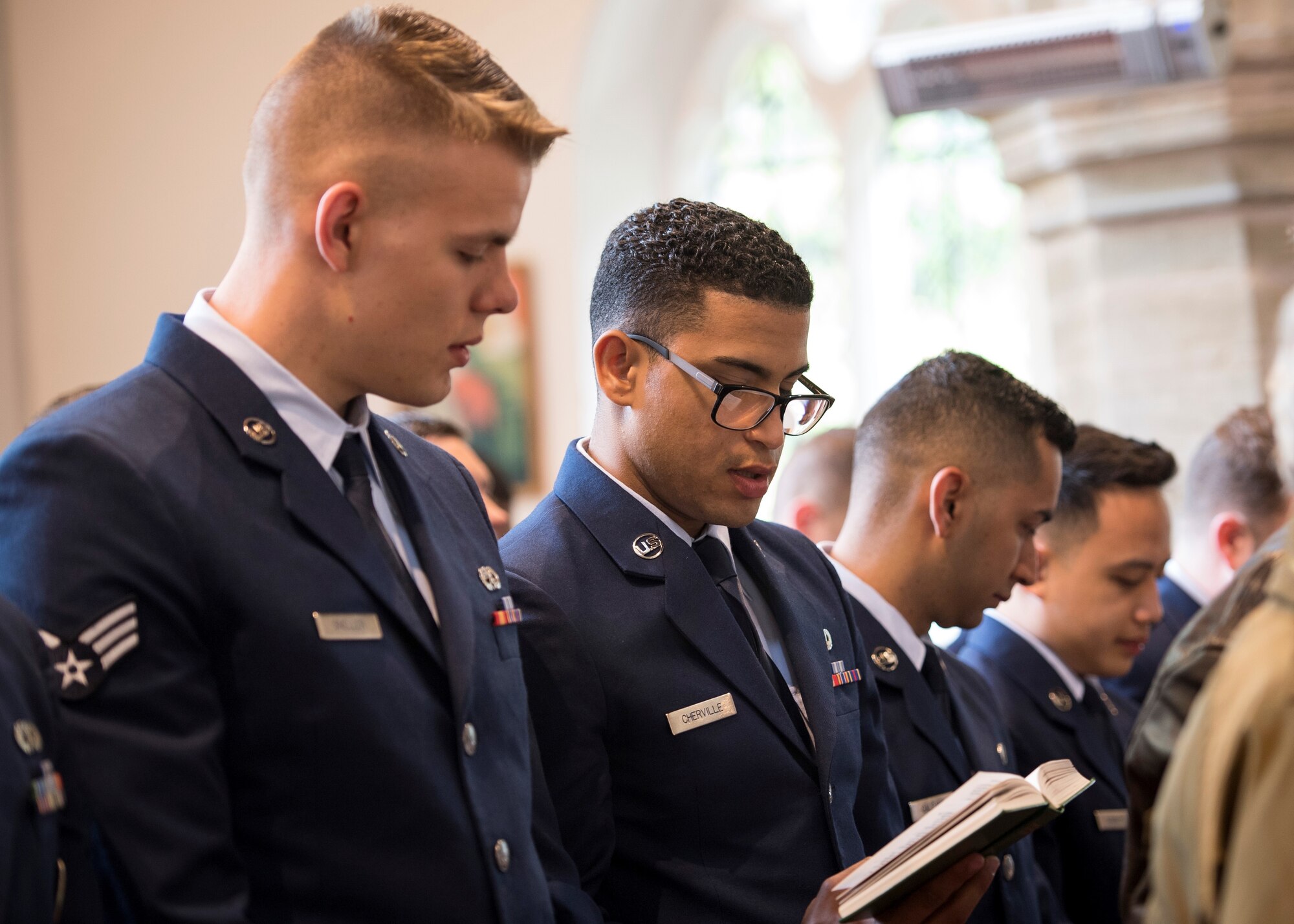 A reverend with the St. John the Baptist Chelveston Church in Chelveston, England, provides a religious service to include Airmen from the 305th Air Mobility Wing, Joint Base McGuire-Dix-Lakehurst, New Jersey, May 26, 2019. The service, which payed respects to the 305th Bomb Group which has evolved into the 305th AMW, was a group of over 4,000 military members that fought in World War II to defend and attack against axis powers. (U.S. Air Force photo by Senior Airman Jake Carter)
