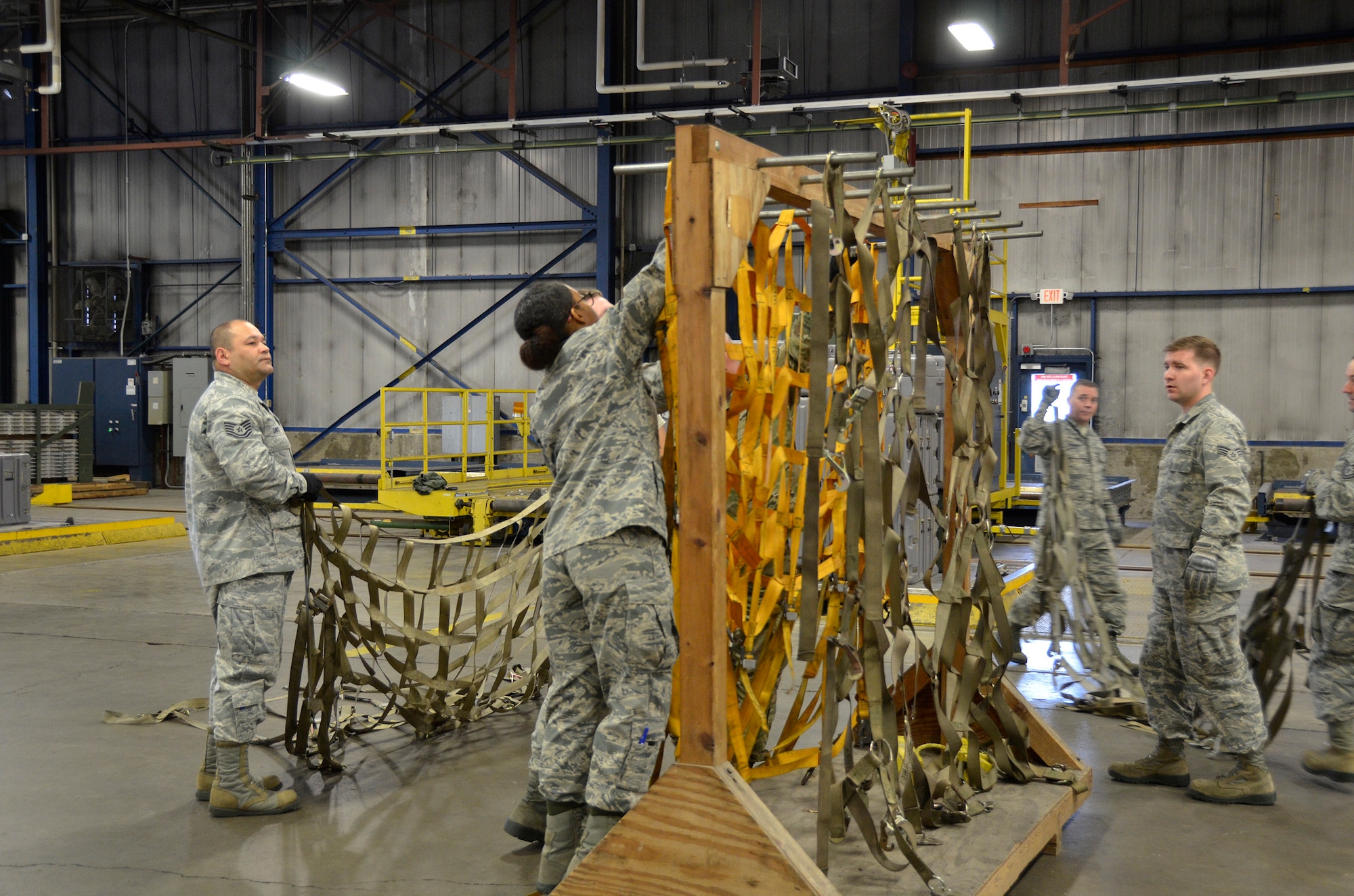 Airmen from the 87th Aerial Port Squadron hang nets after the cargo build up competition during the 87th APS Port Dawg Challenge May 5, 2019. During the May unit training assembly, more than 130 members of the squadron gathered in friendly competition.