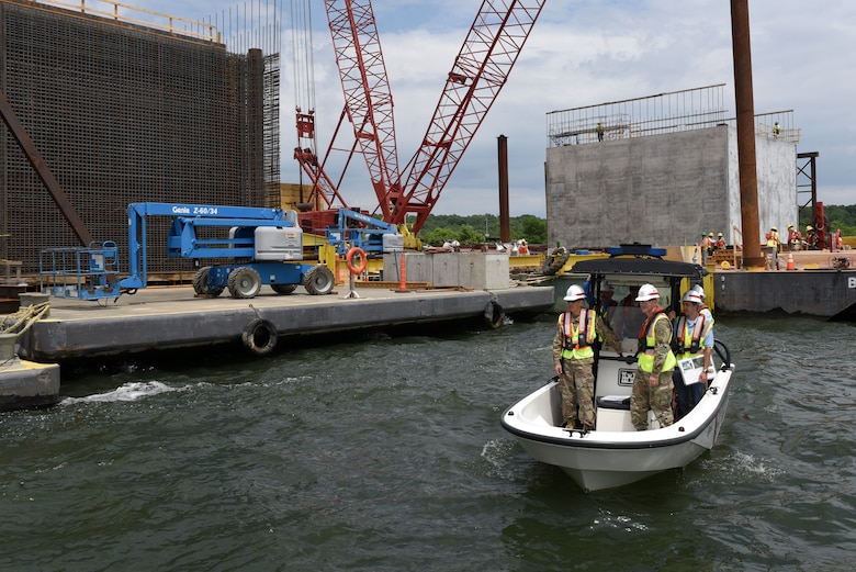 Maj. Gen. Mark Toy, U.S. Army Corps of Engineers Great Lakes and Ohio River Division commander, observes operations to construct concrete shells being assembled on the shoreline of the Tennessee River during a ride in a Corps of Engineers patrol boat at the Kentucky Lock Addition Project in Grand Rivers June 4, 2019.  The shells are being installed to the downstream riverbed for dual use as part of the permanent lock wall and for the coffer dam. (USACE photo by Lee Roberts)