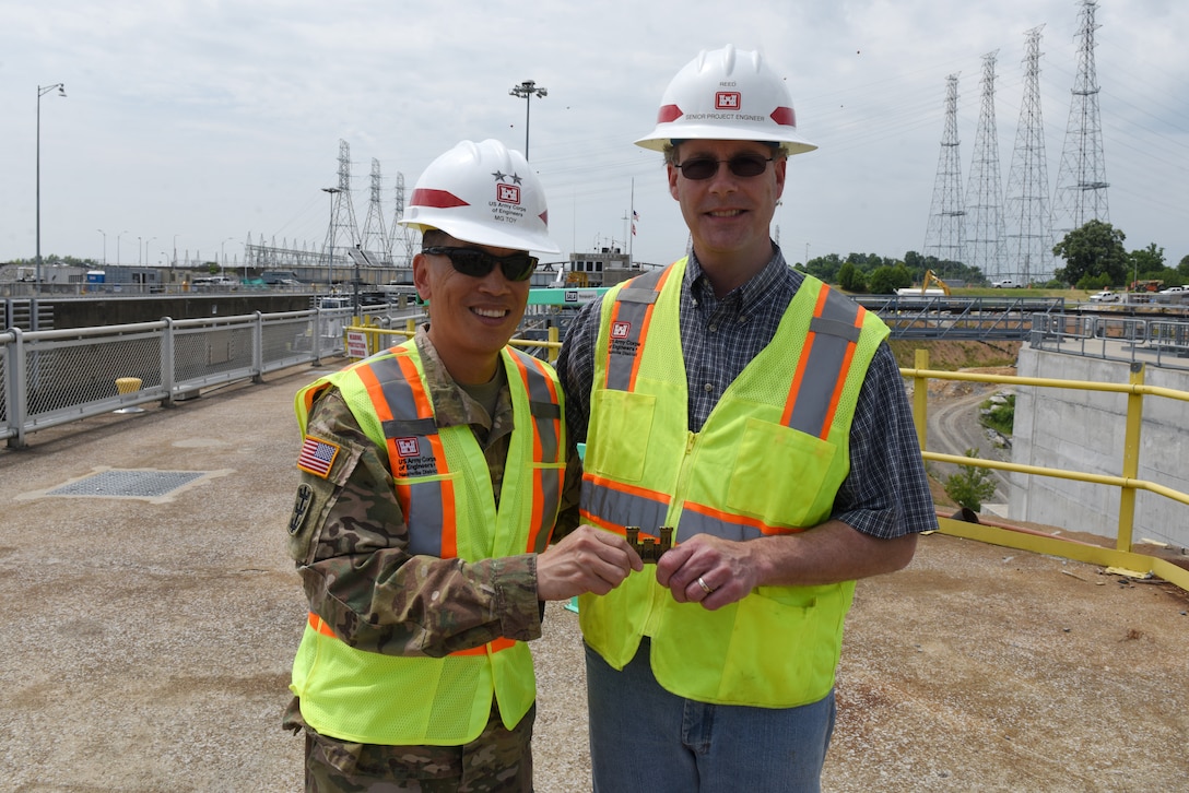 Maj. Gen. Mark Toy (Left), U.S. Army Corps of Engineers Great Lakes and Ohio River Division commander, presents a commander's coin for excellence to John Reed, Kentucky Lock Addition Project senior project engineer, during a visit to Kentucky Lock on the Tennessee River in Grand Rivers, Ky., June 4, 2019. (USACE photo by Lee Roberts)
