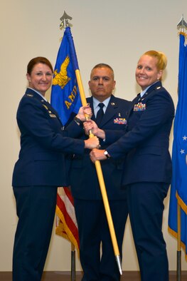 U.S. Air Force Col. Beatrice T. Dolihite, 81st Medical Group service commander, passes the 81st Aerospace Medicine Squadron guidon to Lt. Col. Catherine M. Callender, incoming 81st AMDS commander, during the 81st AMDS change of command ceremony inside the Roberts Maintenance Facility at Keesler Air Force Base, Mississippi, June 4, 2019. The passing of the guidon is a ceremonial symbol of exchanging command from one commander to another. (U.S. Air Force photo by Airman Seth Haddix)