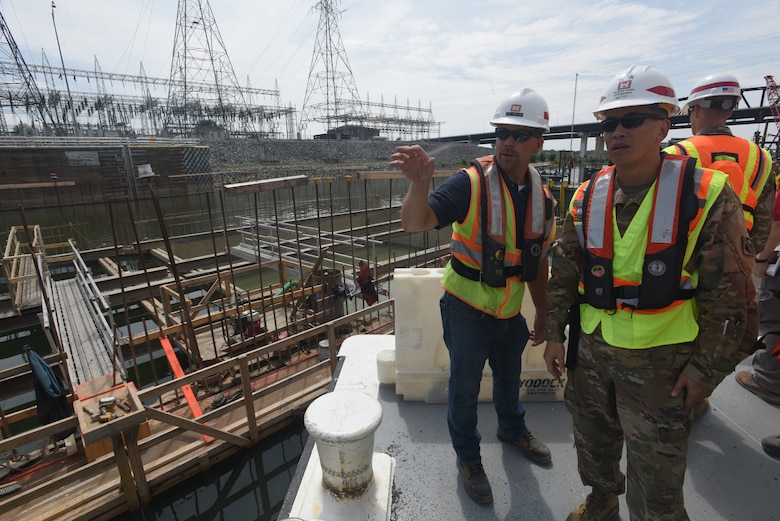 Jody Robinson (Left), U.S. Army Corps of Engineers Nashville District mechanical engineer for the Kentucky Lock Addition Project, briefs Maj. Gen. Mark Toy, Great Lakes and Ohio River Division commander, during a visit to the work site where concrete shells are being installed to the downstream riverbed for dual use as part of the permanent lock wall and for the coffer dam. (USACE photo by Lee Roberts)
