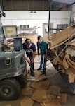 Russell Lepage, left, and Maria Daniel, Joint Base San Antonio Qualified Recycling Program motor vehicle operators, unhitch a cardboard trailer at the JBSA-Lackland Recycling Center so that the cardboard can be unloaded and prepared for processing.