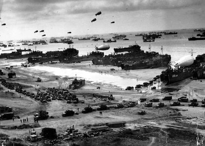 Navy landing ships unload reinforcements, heavy weapons and additional supplies on Omaha Beach in Normandy, France, June 9, 1944.