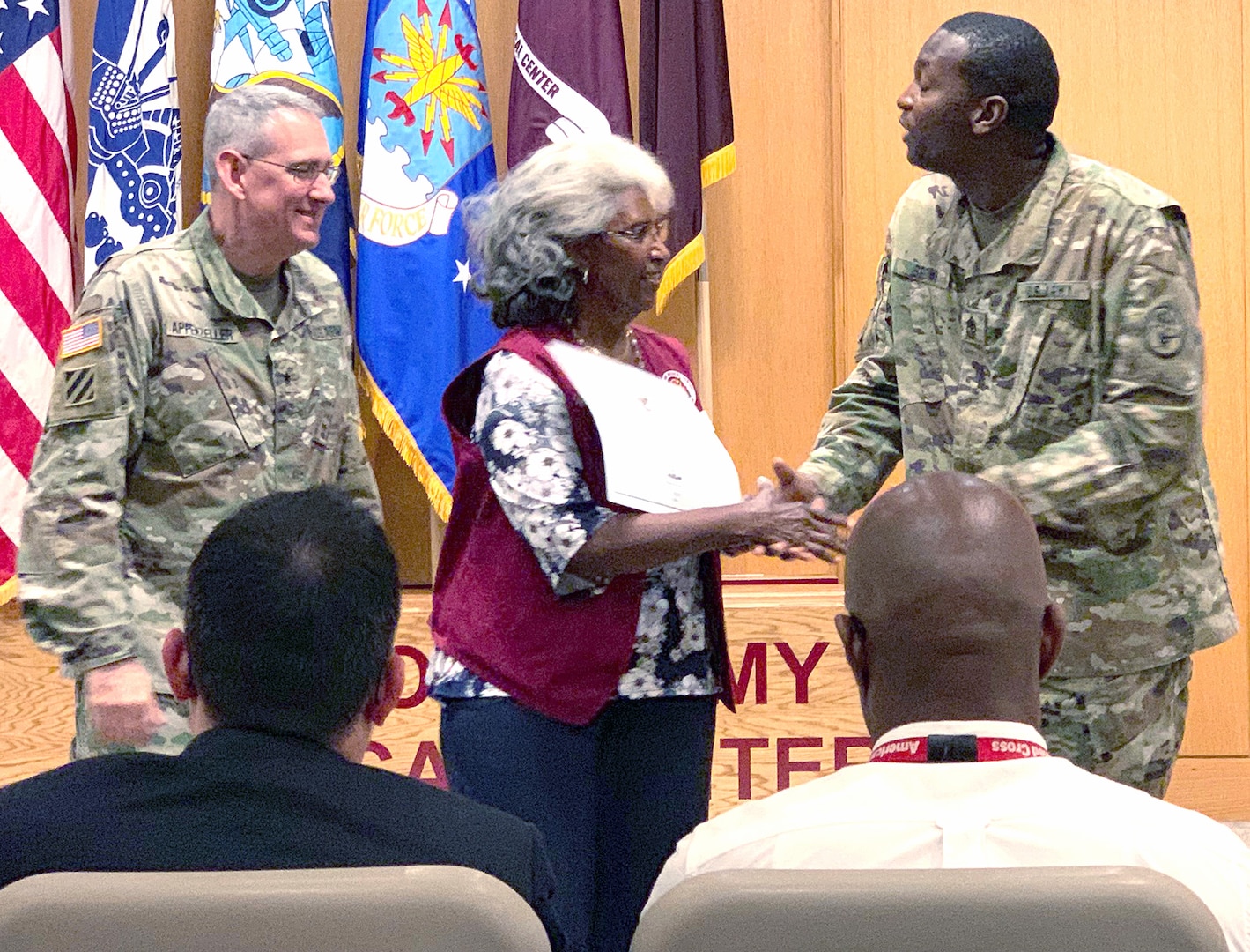 Brig. Gen. George Appenzeller, BAMC commanding general, and Command Sgt. Maj. James Brown present Barbara Williams with the President’s Lifetime Achievement Award May 30 for her more than 4,750 service hours at the community/refill pharmacy at Joint Base San Antonio-Fort Sam Houston.