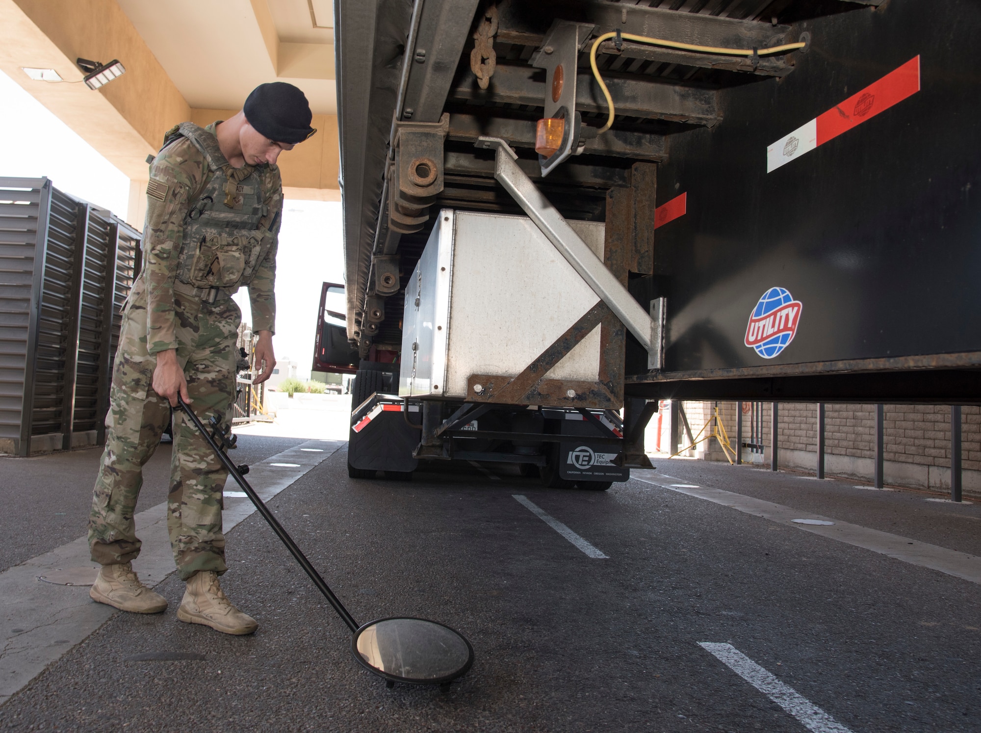 Senior Airman Jaden Cady, 56th Security Forces Squadron law enforcement controller, uses a mirror to inspect underneath a truck that is passing through the South Gate search pit, May 31, 2019, at Luke Air Force Base, Ariz.