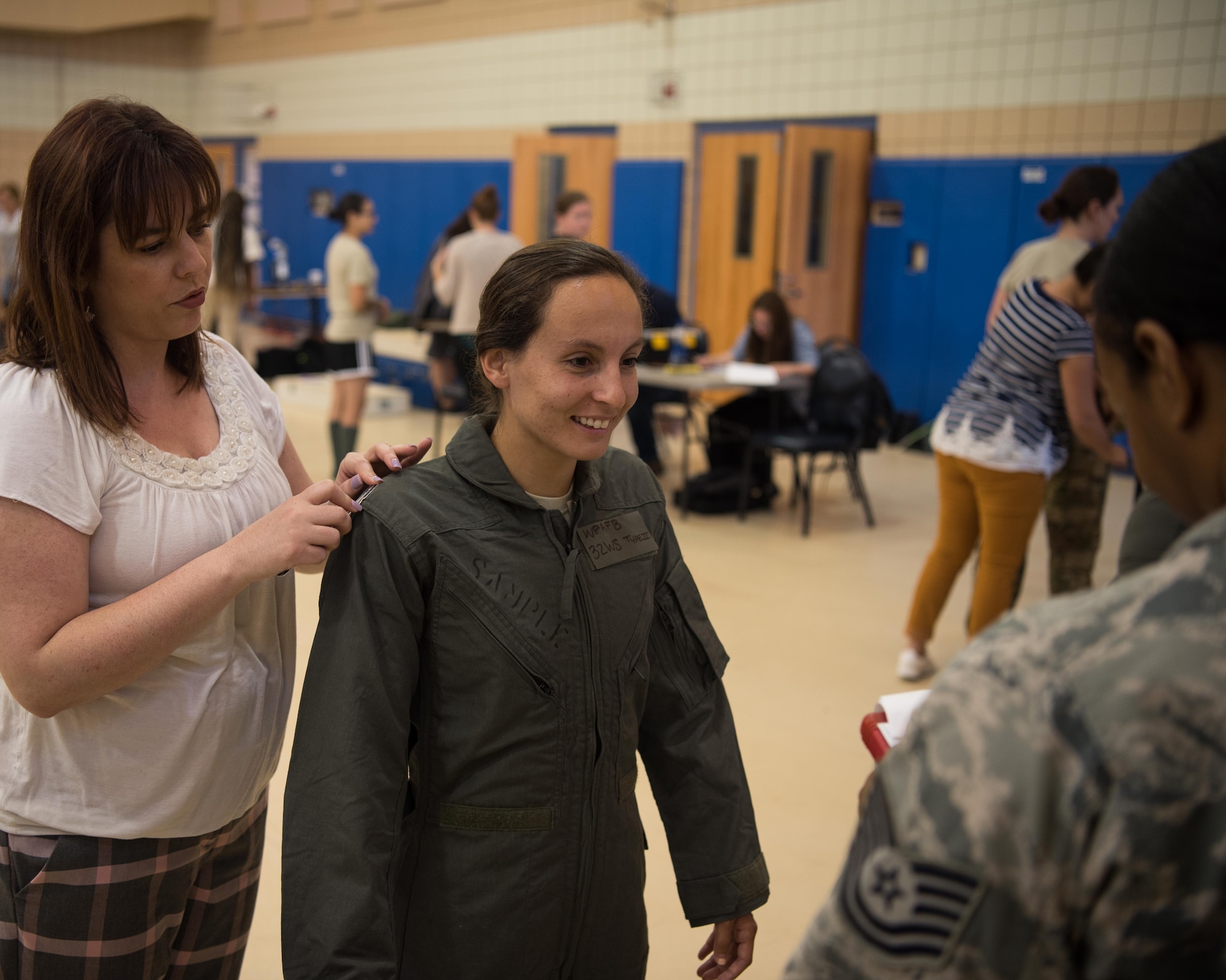 A female aviator gets measurements while in a flight suit during a Female Fitment Event at Joint Base Langley-Eustis, Virginia, June 4, 2019. Traditionally, many flight suits female aviators had to wear were made to the measurements and specifications of their male counterparts. (U.S. Air Force photo by Airman 1st Class Marcus M. Bullock)