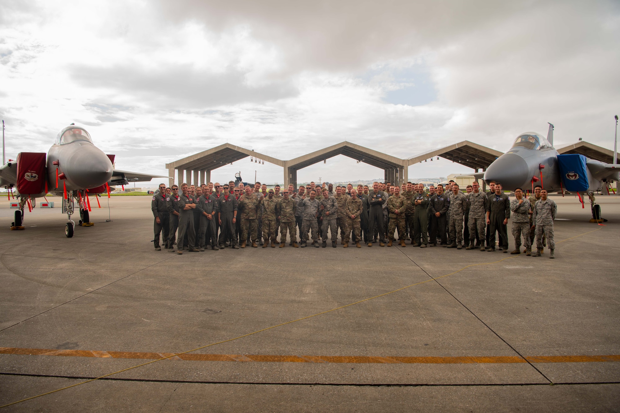 Members of the 44th and 67th Fighter Squadrons and Aircraft Maintenance Units pose for a group photo during a dedicated crew chief ceremony, May 31, 2019, at Kadena Air Base, Japan.