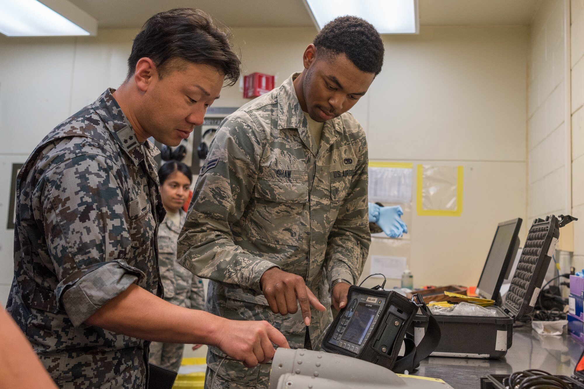 U.S. Air Force Airman 1st Class Zacharius Shaw, nondestructive inspection apprentice assigned to the 18th Equipment Maintenance Squadron, demonstrates how to use an eddy current nortec 600 inspection unit during a bilateral training exercise with the Japan Air Self-Defense Force May 23, 2019, on Kadena Air Base, Japan. The 18th EMS holds frequent bilateral training exercises with JASDF counterparts to build stronger partnerships and maintain a constant level of readiness. (U.S. Air Force photo by Airman 1st Class Cynthia Belío)