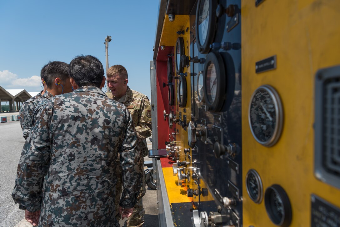 U.S. Air Force Tech. Sgt. Adam Decker, south aerospace ground equipment section chief assigned to the 18th Equipment Maintenance Squadron, demonstrates how to use the hydraulic test stand during a bilateral training exercise with the Japan Air Self-Defense Force May 23, 2019, on Kadena Air Base, Japan. This bilateral training exercise focused on teaching JASDF members the functions and purpose of aerospace ground equipment and nondestructive inspection flights. (U.S. Air Force photo by Airman 1st Class Cynthia Belío)