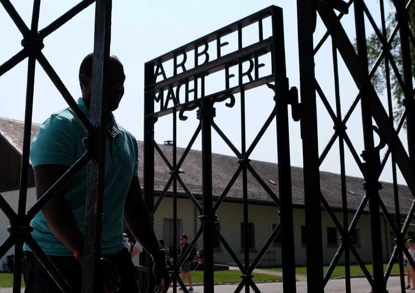 DACHAU, Germany—U.S. Army 2nd Lt. Adrian A. White, the S4 of the 83rd Combat Sustainment Support Battalion, 510th Regional Support Group, 7th Mission Command walks through the front gate of the Dachau Concentration Camp Memorial Site on the eve of the 75th anniversary of the World War II Allied D-Day invasion to end National Socialist Fascism in Europe on June 5, 2019. (U.S. Army photo by Sgt. Daniel J. Friedberg, 7th Mission Support Public Affairs)