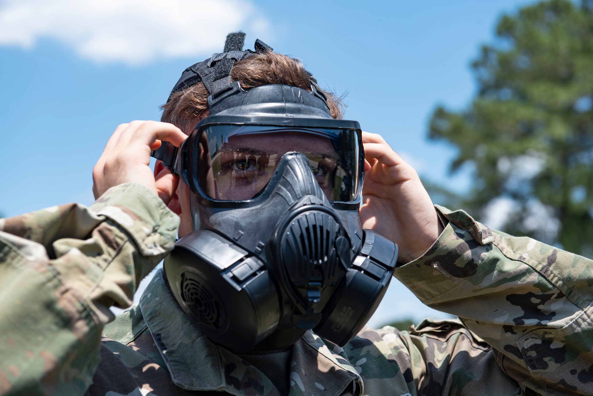 A U.S. service member dons his gas mask during chemical, biological, radiological and nuclear annual training at Shaw Air Force Base, S.C., May 21, 2019