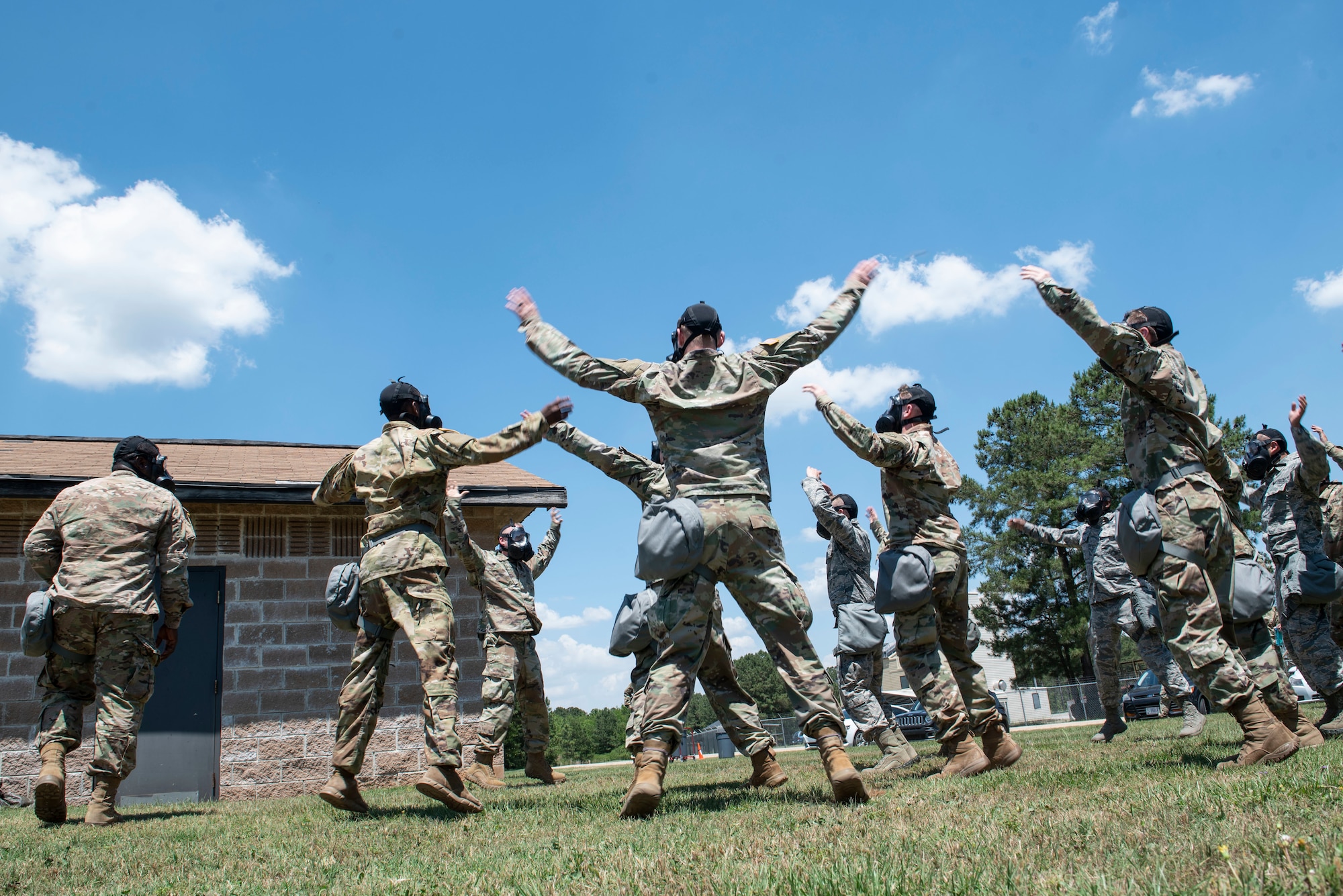 U.S. Soldiers and Airmen do jumping jacks prior to entering a gas chamber at Shaw Air Force Base, S.C., May 21, 2019.