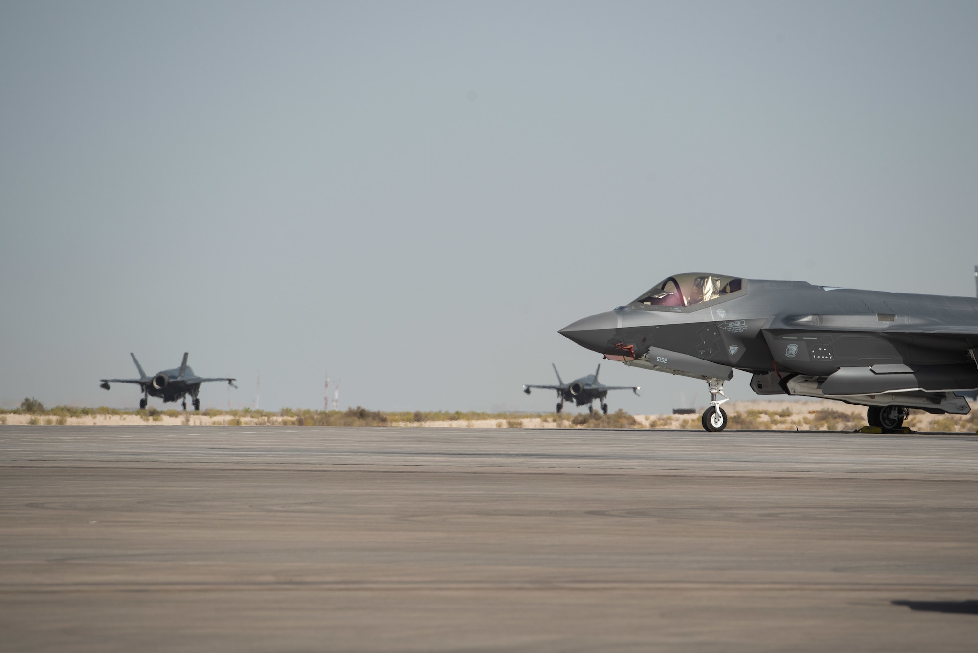 Two F-35A Lightning IIs, assigned to the 4th Expeditionary Fighter Squadron, taxi to the runway June 6, 2019, at Al Dhafra Air Base, United Arab Emirates.