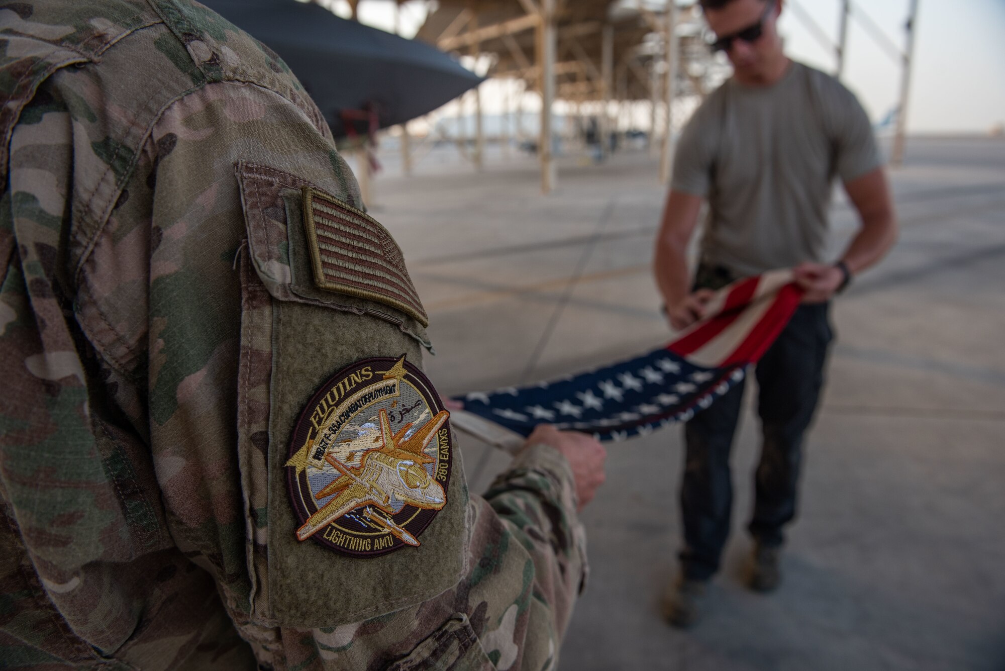 Senior Airman Quinton Bullock, 380th Expeditionary Aircraft Maintenance Squadron F-35A Lightning II crew chief, folds a 48-star flag June 6, 2019, at Al Dhafra Air Base, United Arab Emirates.