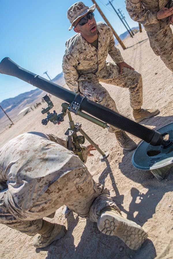 Lance Cpl. Alfredo Mercedes, right, a mortarman with Weapons Company, 3rd Battalion, 25th Marine Regiment, 4th Marine Division, braces after a simulated fire of an 81mm mortar system while executing remedial exercises during Integrated Training Exercise 4-19 at Camp Wilson aboard the Marine Corps Air Ground Combat Center, Twentynine Palms, Calif., June 5, 2019. ITX measures our ability to provide a cohesive, trained, and ready capability in support of service and Combatant Commander requirements. (U.S. Marine Corps photo by Lance Cpl. Preston L. Morris)