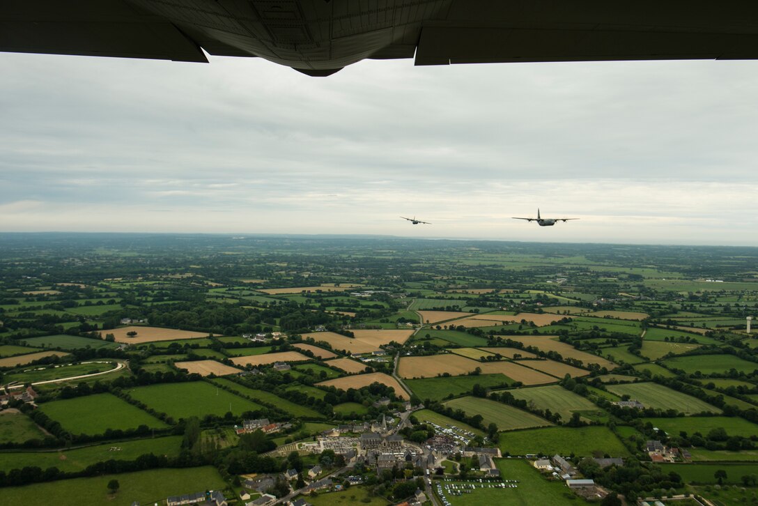 Two U.S. Air Force C-130J Super Hercules, assigned to the 37th Airlift Squadron, Ramstein Air Base, Germany, flyover a ceremony in Picauville, France, June 4, 2019. A formation of four aircraft flew over the ceremony, honoring airborne and aircrew members involved in the invasion of Normandy. (U.S. Air

Force photo by Senior Airman Devin M. Rumbaugh)