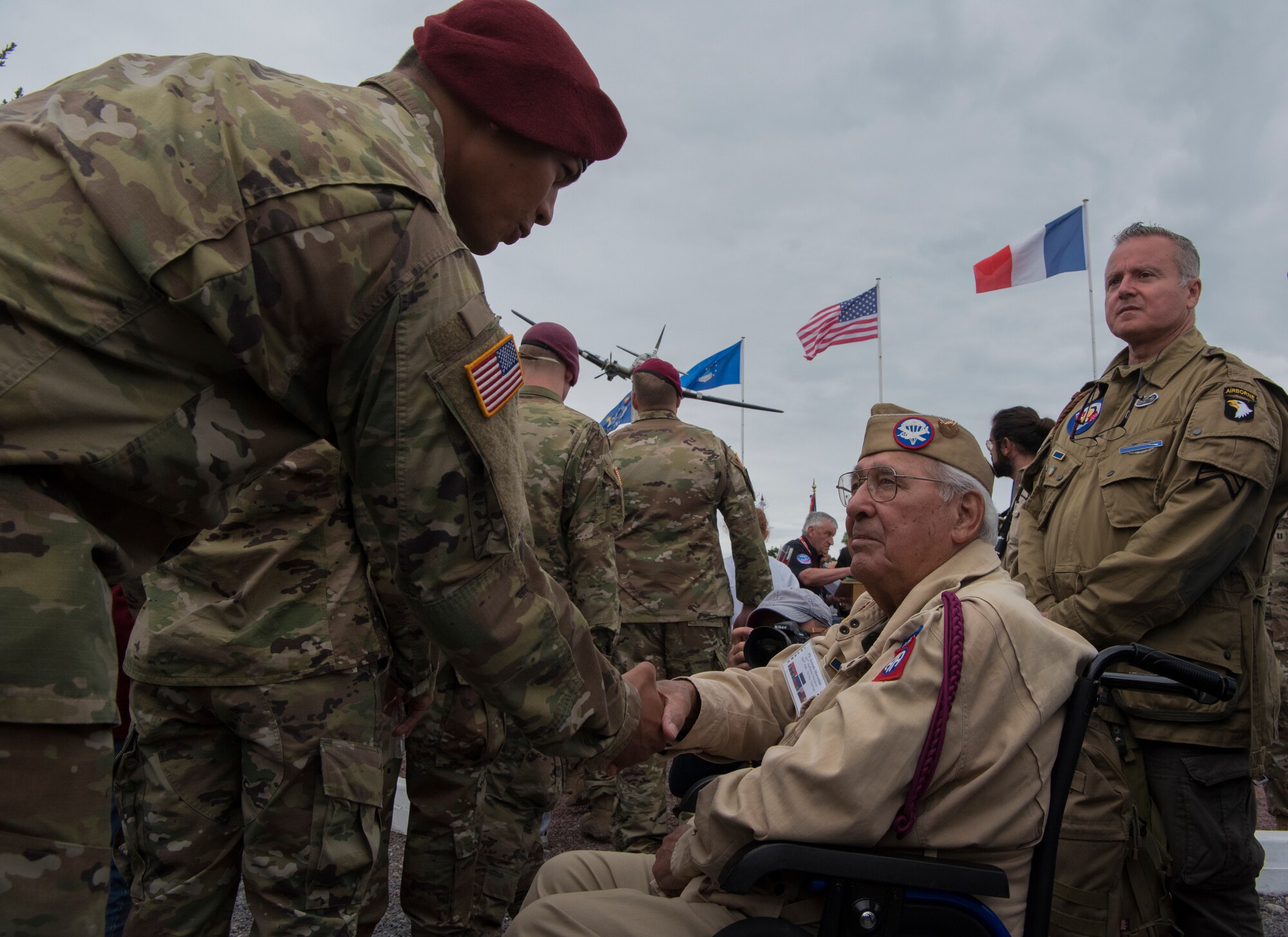 A U.S. Army airborne infantryman shakes the hand of retired Private First Class Joseph Morettini, 82nd Airborne, 508th Regiment, Easy Company, during a ceremony held to honor all airborne troops and flight crew that served on D-Day in Picauville, France, June 4, 2019. On June 6, 1944, Morettini dropped from midnight skies into Normandy with the objective to overtake an enemy stronghold near Picauville. During the ceremony’s conclusion, Morettini remarked to each active U.S. airborne infantrymen he shook hands with: “I dropped here 75 years ago.” (U.S. Air Force photo by Senior Airman Kristof J. Rixmann)