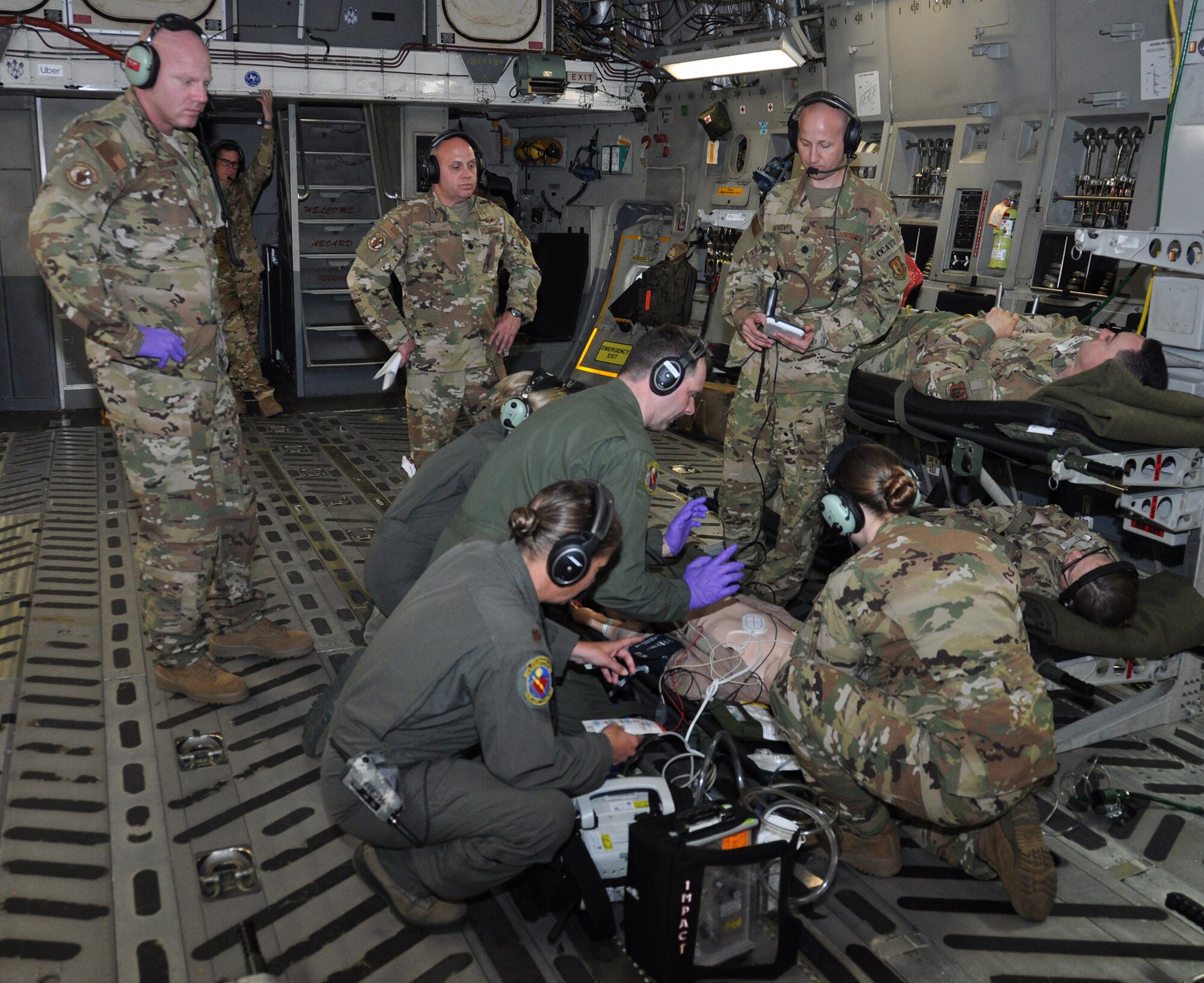 Lt. Col. Derek Sorensen, (standing far right) U.S. Air Force School of Aerospace Medicine medical director for en route care training, evaluates a 445th Aeromedical Evacuation Squadron crew during an AE readiness flight, May 8, 2019.