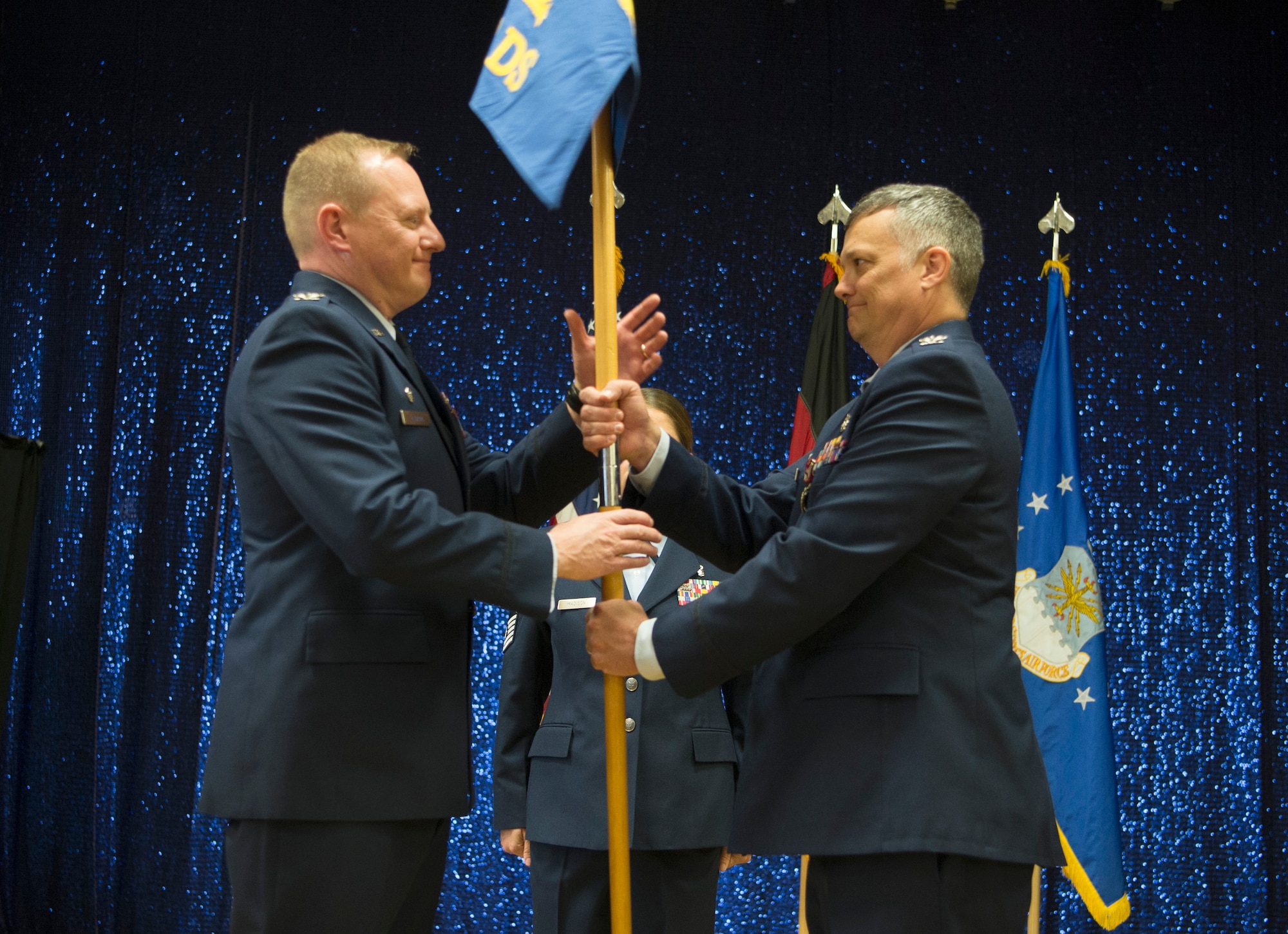 The guidon symbolized the authority Lagrou placed on Jones, who then relinquished command over the 52nd DS as the flag exchanged hands