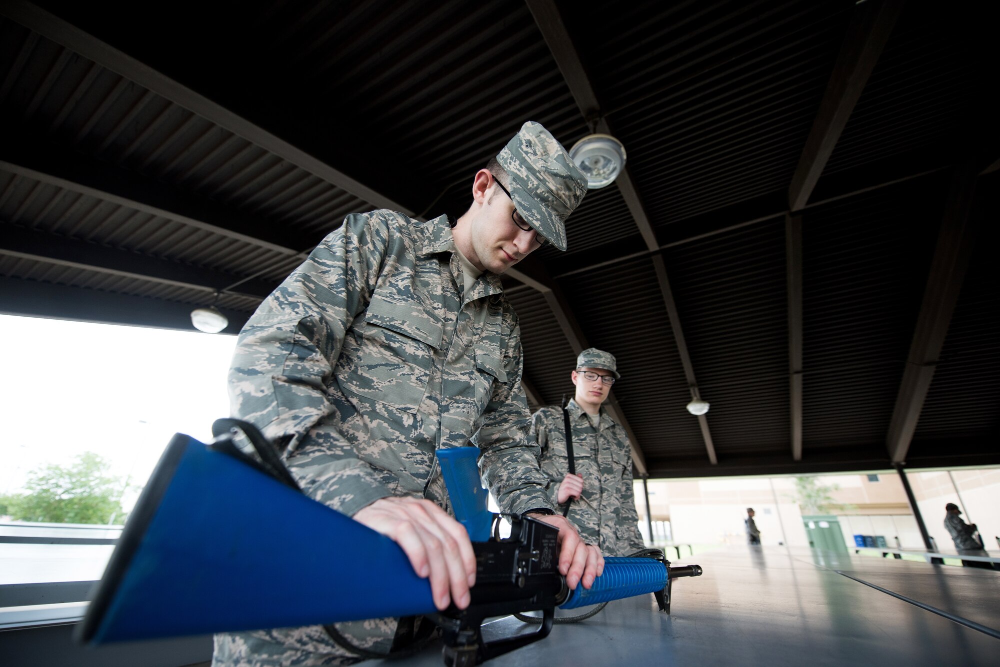 U.S. Air Force basic military training trainees practice assembling and disassembling their M-16 trainer weapon, May 2, 2019, at Joint Base San Antonio-Lackland. Airmen must know how to fix malfunctions in order to continue the fight and protect their fellow Wingman. Basic military training is an eight-week course designed to challenge Airmen mentally and physically. (U.S. Air Force photo by Sarayuth Pinthong)