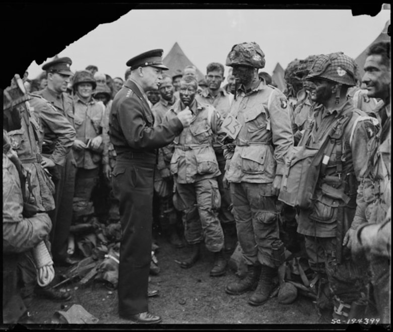 General Dwight D. Eisenhower gives the order of the Day on June 6, 1944.  "Full victory-nothing else" to paratroopers in England, just before they board their airplanes to participate in the first assault in the invasion of the continent of Europe.
(National Archives courtesy photo)