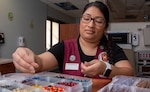 Brooke Army Medical Center Retiree Activity Group volunteer Elvira Morales sorts beads in the neonatal intensive care unit at BAMC May 29. The beads tell the child’s medical story and are symbols of courage that acknowledge milestones they have achieved and procedures they have gone through as part of their medical treatment plan. The Beads of Courage Program is a resilience-based, arts-in-medicine, supportive care program designed to support children and their families coping with serious illness. The beads tell the child’s medical story and are symbols of courage that acknowledge milestones they have achieved and procedures they have gone through as part of their medical treatment plan.