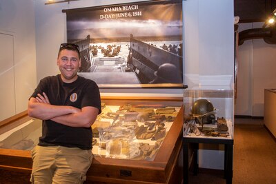 Maj. Michael Hart and some of the World War II artifacts from his personal collection.