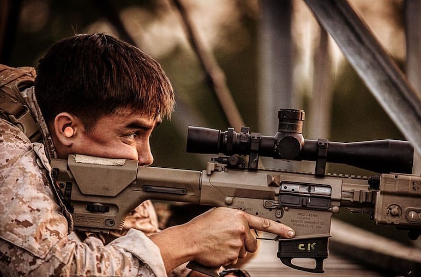 A Marine looks through the scope of an M110 semi-automatic sniper rifle.