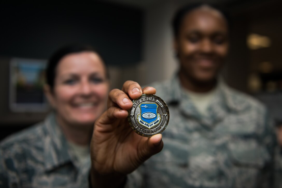 U.S. Air Force Command Chief Master Sgt. Barbara Gilmore, 932nd Airlift Wing, presents Airman Jaisha Walker, 932nd Force Support Squadron, with a Wing coin at Scott Air Force Base, Illinois, June 2, 2019. Gilmore coined Walker for saying “Sir I just want you to know you’re never alone” during a talk with Maj. Gen. Craig L. La Fave, Commander, 22nd Air Force, Air Force Reserve Command, Dobbins Air Reserve Base, Georgia,  about the Individual Mobilization Augmentee (IMA) program. (U.S. Air Force photo by Master Sgt. Christopher Parr)