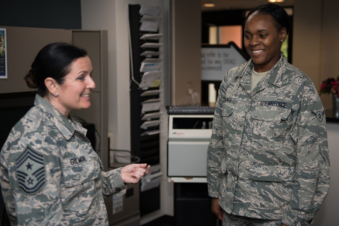 U.S. Air Force Command Chief Master Sgt. Barbara Gilmore, 932nd Airlift Wing, presents Airman Jaisha Walker, 932nd Force Support Squadron, with a Wing coin at Scott Air Force Base, Illinois, June 2, 2019. Gilmore coined Walker for saying “Sir I just want you to know you’re never alone” during a talk with Maj. Gen. Craig L. La Fave, Commander, 22nd Air Force, Air Force Reserve Command, Dobbins Air Reserve Base, Georgia,  about the Individual Mobilization Augmentee (IMA) program. (U.S. Air Force photo by Master Sgt. Christopher Parr)