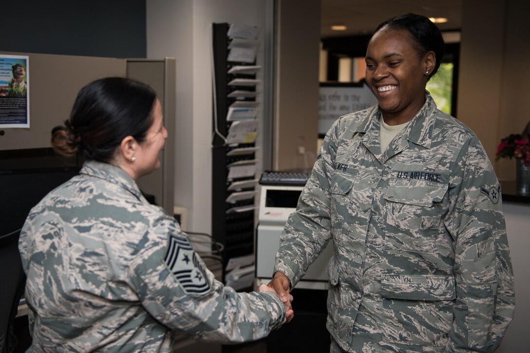 U.S. Air Force Command Chief Master Sgt. Barbara Gilmore, 932nd Airlift Wing, presents Airman Jaisha Walker, 932nd Force Support Squadron, with a Wing coin at Scott Air Force Base, Illinois, June 2, 2019. Gilmore coined Walker for saying “Sir I just want you to know you’re never alone” during a talk with Maj. Gen. Craig L. La Fave, Commander, 22nd Air Force, Air Force Reserve Command, Dobbins Air Reserve Base, Georgia,  about the Individual Mobilization Augmentee (IMA) program. (U.S. Air Force photo by Master Sgt. Christopher Parr)
