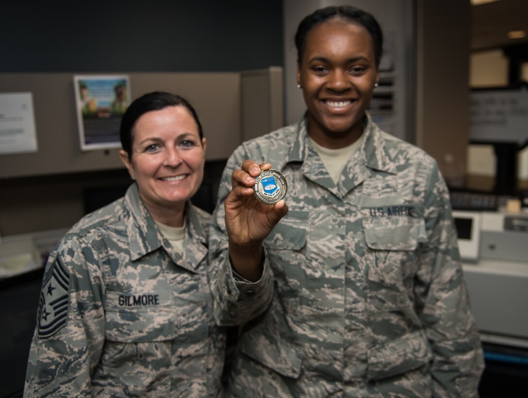 U.S. Air Force Command Chief Master Sgt. Barbara Gilmore, 932nd Airlift Wing, presents Airman Jaisha Walker, 932nd Force Support Squadron, with a Wing coin at Scott Air Force Base, Illinois, June 2, 2019. Gilmore coined Walker for saying “Sir I just want you to know you’re never alone” during a talk with Maj. Gen. Craig L. La Fave, Commander, 22nd Air Force, Air Force Reserve Command, Dobbins Air Reserve Base, Georgia,  about the Individual Mobilization Augmentee (IMA) program. (U.S. Air Force photo by Master Sgt. Christopher Parr)