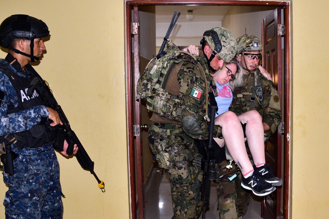 Dominican Republic, Mexican Navy, and the U.S. Army personnel assist a simulated civilian casualty during the final training scenario for the first phase of Exercise Tradewinds 19.