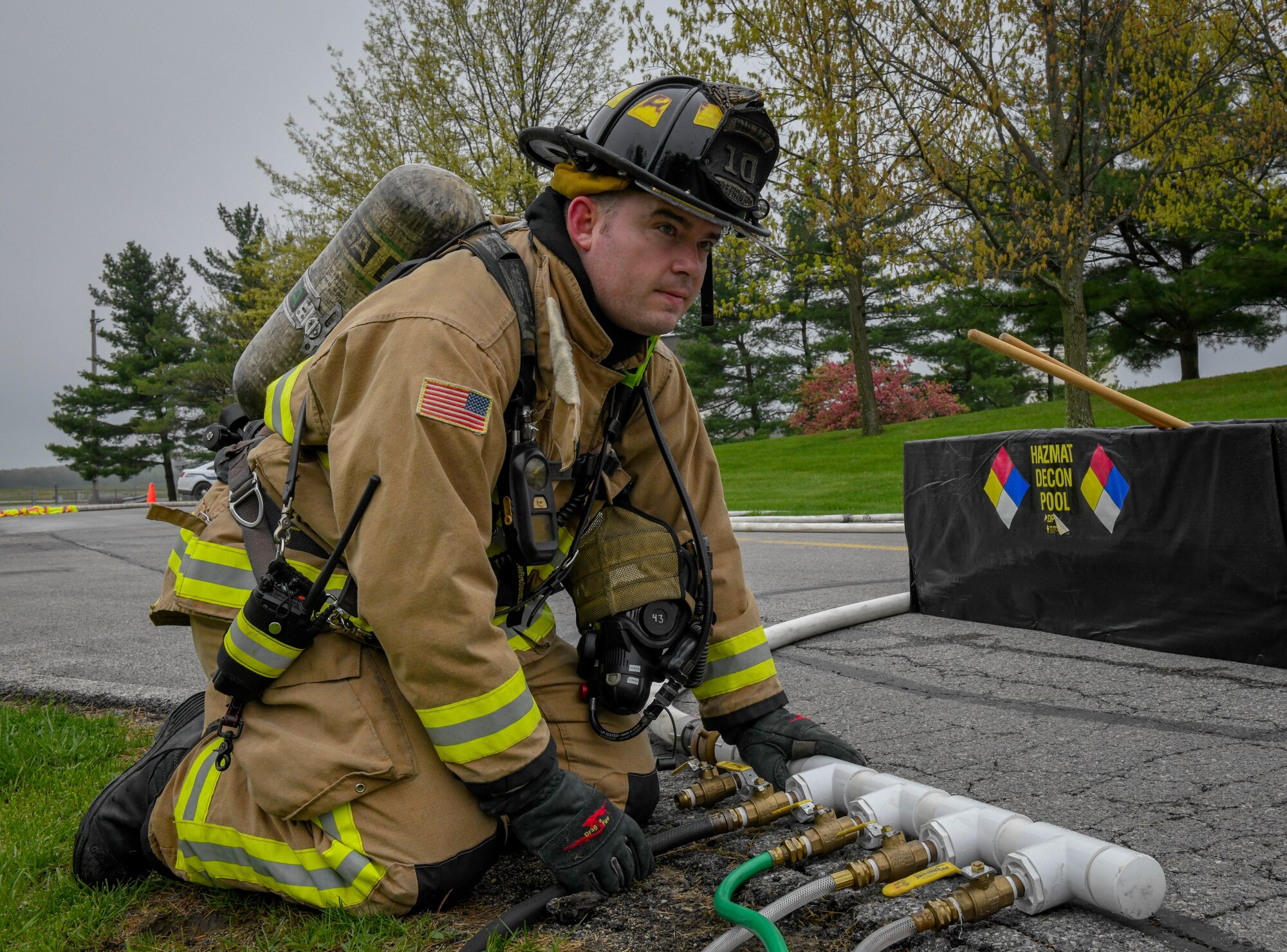 Reserve Citizen Airman Chad Anderson, a firefighter assigned to the 910th Civil Engineer Fire Department here, hooks up a HAZMAT hose during a Weapons of Mass Destruction exercise here, May 5, 2019.