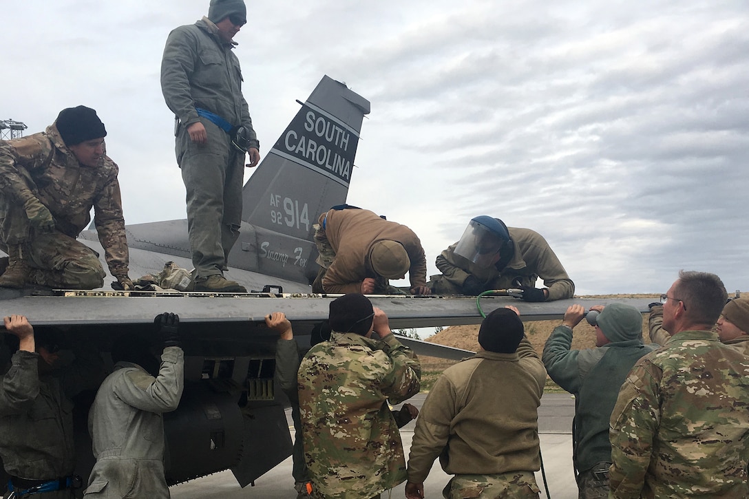 U.S. Air Force F-16 aircraft maintainers, assigned to the South Carolina Air National Guard’s 169th Fighter Wing, remove the right wing leading edge flap after the discovery of a damaged actuator on one of their F-16 Fighting Falcons during Arctic Challenge Exercise 2019 at Kallax Air Base, Sweden, May 23, 2019.