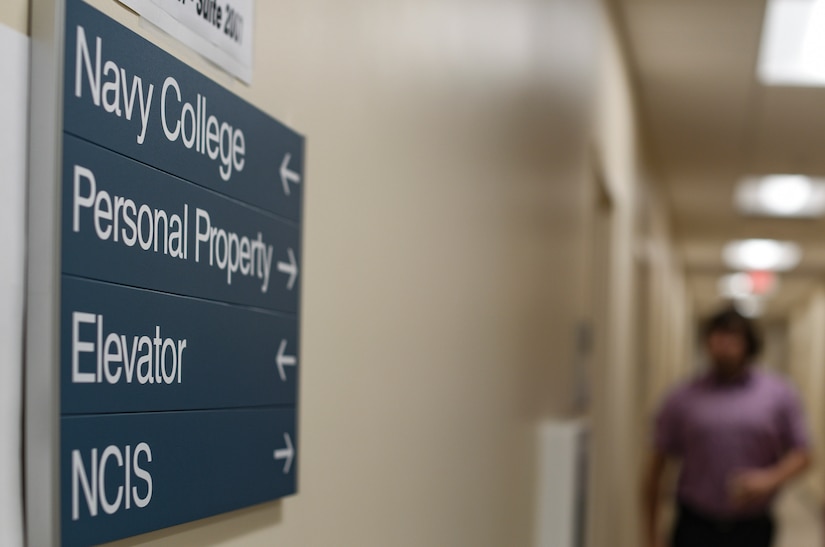 A sign indicating the future location of the Joint Base Charleston Naval College classrooms and administrative offices hangs on a wall June 4, 2019, at Joint Base Charleston’s Naval Weapons Station in Goose Creek S.C. The new campus will offer college classes in August 2019 for service members and their families to progress toward their educational goals.