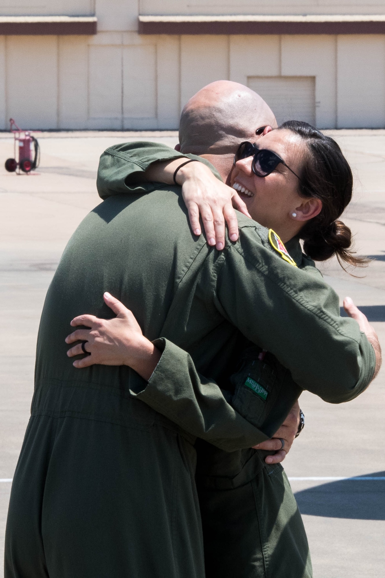 Maj. John R. Blankenship, a B-52 Stratofortress pilot with the 96th Bomb Squadron, hugs his wife Maj. Natasha E. Blankenship, a C-17 Globemaster III pilot with the 183rd Airlift Squadron in Jackson, Mississippi, after she landed her aircraft to be put on display as apart of the Barksdale Defenders of Liberty Air Show at Barksdale Air Force Base, La., May 16, 2019. The Blankenships have duty stations over 200 miles apart and rarely see each other in action. (U.S. Air Force photo by Airman Jacob B. Wrightsman)