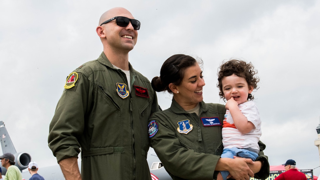 Maj. John R. Blankenship, a B-52 Stratofortress pilot with the 96th Bomb Squadron, his wife Maj. Natasha E. Blankenship, a C-17 Globemaster III pilot with the 183rd Airlift Squadron in Jackson, Mississippi, and their year and a half old son, Dane, enjoy the Barksdale Defenders of Liberty Air Show at Barksdale Air Force Base, La., May 18, 2019. Over 80,000 spectators  from the Ark-La-Tex region May 18 and 19, 2019 to witness a full weekend of military and civilian aircraft performances and displays. (U.S. Air Force photo by Airman Jacob B. Wrightsman)