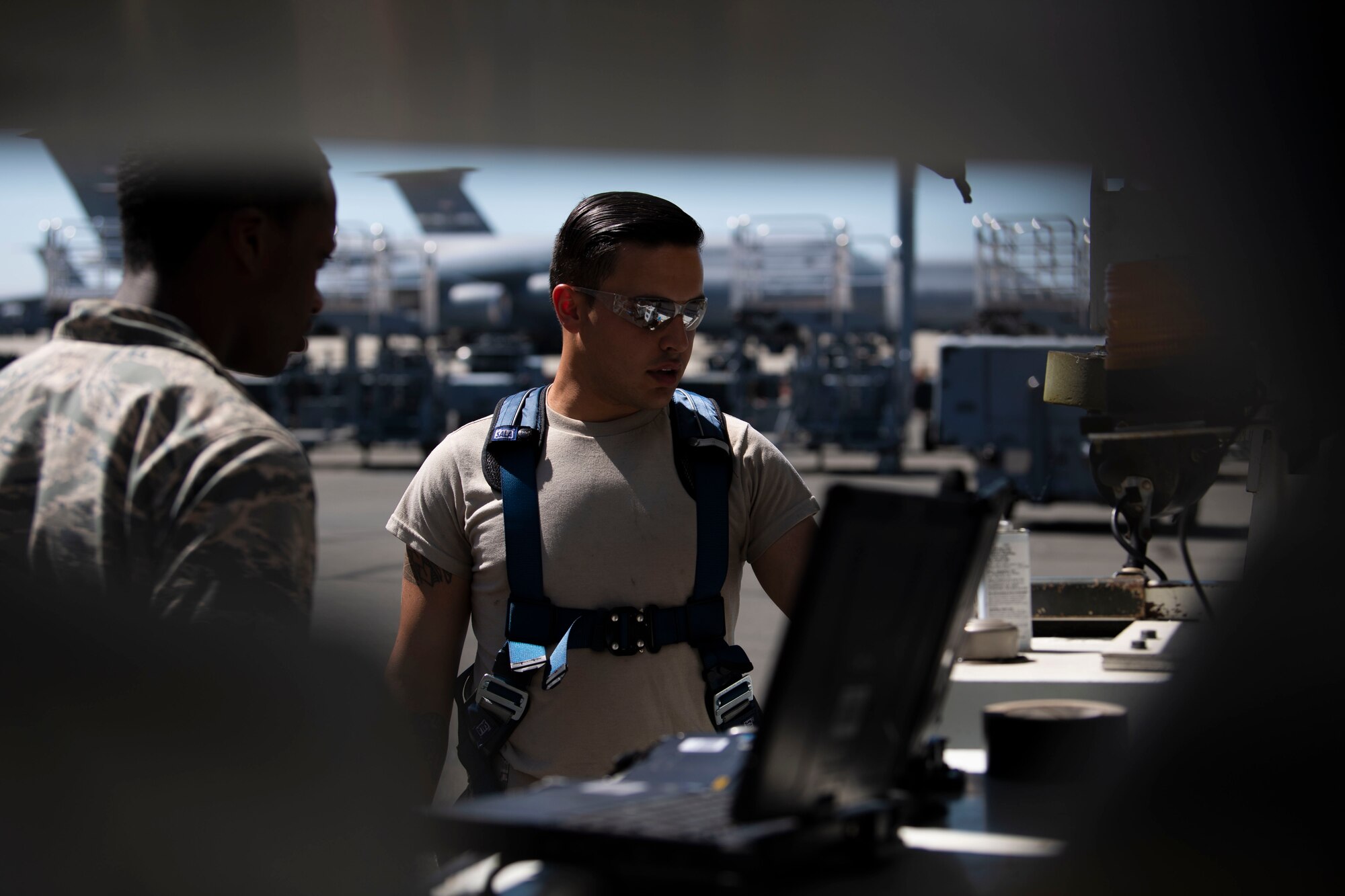 U.S. Air Force Airman David Yerushalmi, right, 60th Maintenance Squadron aerospace ground equipment technician, looks up operating procedures on a computer with Airman Myrtho Pierre, 60th MXS AGE technician, June 4, 2019, at Travis Air Force Base, California. From inspecting and troubleshooting to making hands-on repairs and maintaining proper standards, the AGE flight works 24/7 overcoming obstacles to ensure that other maintenance teams have the equipment they need to launch aircraft on time. (U.S. Air Force photo by Airman 1st Class Jonathon Carnell)