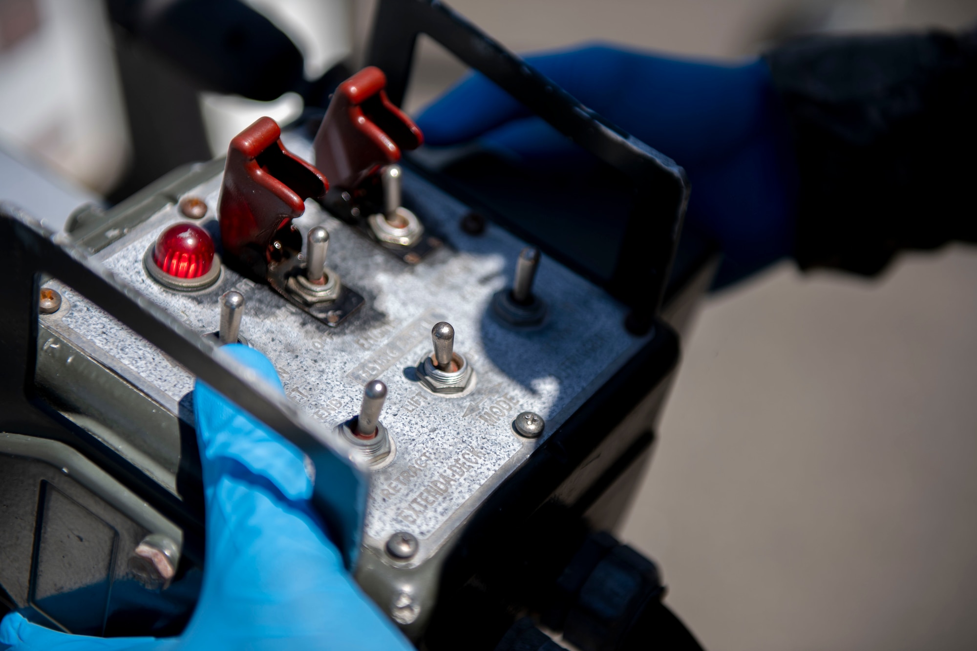 U.S. Air Force Airman Myrtho Pierre, 60th Maintenance Squadron aerospace ground equipment technician, operates the controls to a hydraulic scissor lift maintenance stand June 4, 2019, at Travis Air Force Base, California. The AGE flight ensures other maintenance teams have the equipment they need to launch aircraft on time. (U.S. Air Force photo by Airman 1st Class Jonathon Carnell)