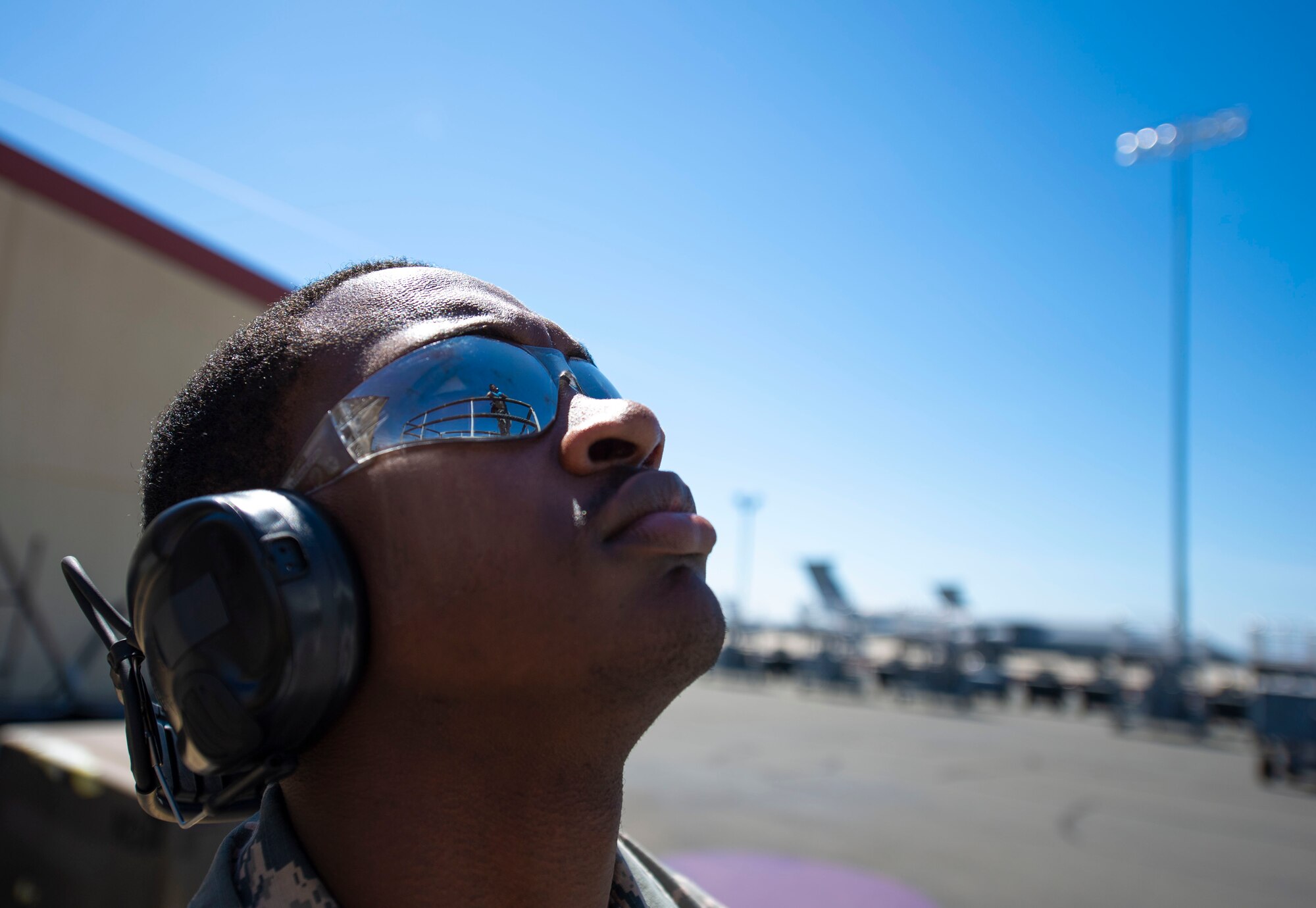 U.S. Air Force Airman Myrtho Pierre, 60th Maintenance Squadron aerospace ground equipment technician, listens to Airman David Yerushalmi, 60 MXS technician, to properly operate a hydraulic scissor lift maintenance stand June 4, 2019, at Travis Air Force Base, California. The AGE flight ensures other maintenance teams have the equipment they need to launch aircraft on time. (U.S. Air Force photo by Airman 1st Class Jonathon Carnell)